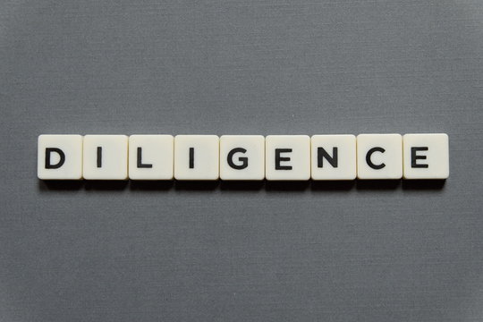 Diligence word made of square letter word on grey background.