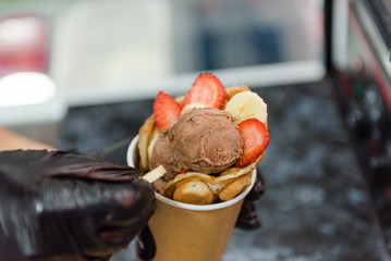 Add ice cream to waffles. Cooking sweet dessert. Cook the waffles. Decoration dishes.