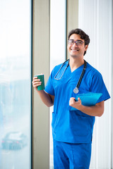 Young handsome doctor working in the hospital 