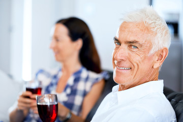 Fototapeta premium Portrait of a couple having a glass of red wine
