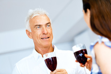 Portrait of a couple having a glass of red wine