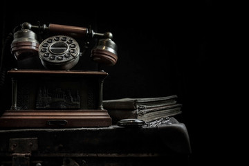 Vintage background. Old telephone and books.