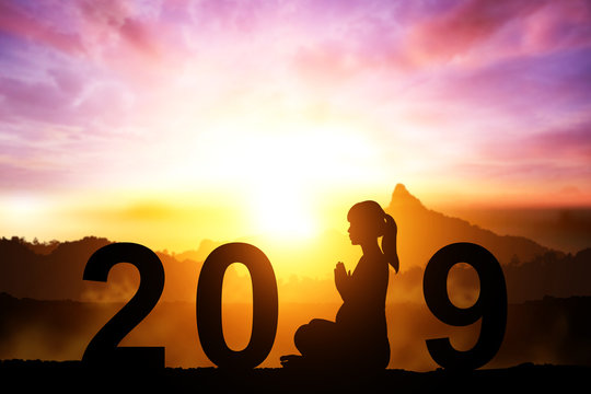 silhouette of Pregnant women yoga in 2019 text for happy new year concept