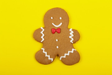 Christmas cookies, gingerbread In the form of a man on yellow background. Christmas background