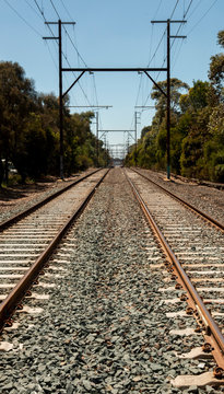 Train Tracks at Level Crossing Disappear Over the Horizon