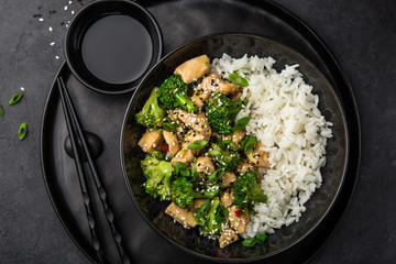 teriyaki chicken and broccoli with steamed rice in bowl