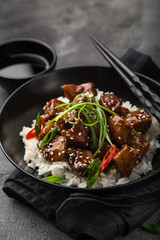 sweet sticky pork served with chives and  sesame seeds