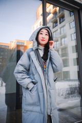 fashion outdoor photo of gorgeous sensual woman with black hair in elegant clothes  walking by winter city