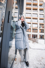 fashion outdoor photo of gorgeous sensual woman with black hair in elegant clothes  walking by winter city