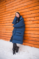 fashion outdoor photo of gorgeous sensual woman with black hair in elegant clothes  walking by winter city