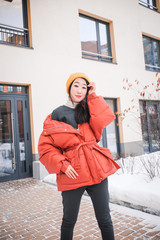 fashion outdoor photo of gorgeous sensual woman with black hair in elegant clothes  walking by winter city