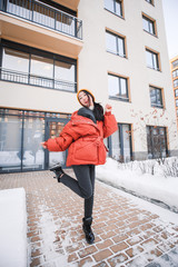 fashion outdoor photo of gorgeous sensual woman with black hair in elegant clothes  walking by winter city