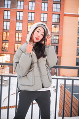 fashion outdoor photo of gorgeous sensual woman with black hair in elegant clothes  walking by winter city