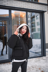 fashion outdoor photo of gorgeous sensual woman with black hair in elegant clothes  walking by winter city