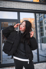 Obraz premium fashion outdoor photo of gorgeous sensual woman with black hair in elegant clothes walking by winter city