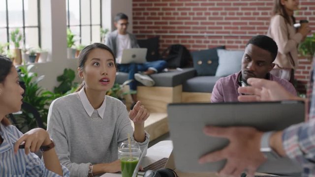 multi ethnic group of engineers developing mobile software application team leader man using digital tablet computer sharing ideas showing shareholders development timeline in office presentation
