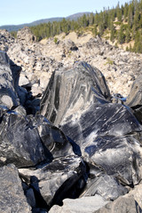 Large chunks of black obsidian glass exposed