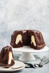 delicious chocolate bundt cake with creamcheese filling  and chocolate glaze on  dark background