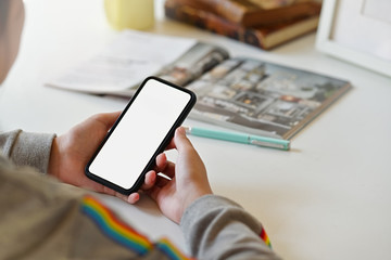 Young freelance woman hand holding mobile smart phone