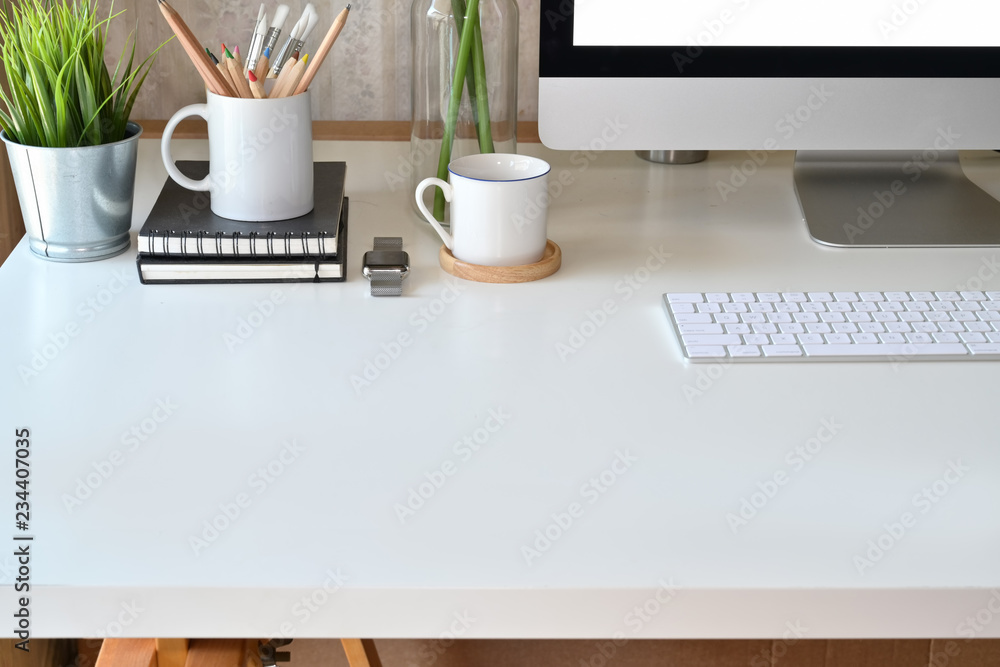 Poster loft workspace white wood desk with computer and copy space.