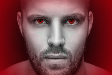 Obraz premium Portrait of a young serious man, in whose eyes the reflected national flag of Morocco, against an isolated black background and flag