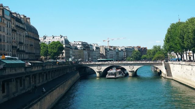 A Riverboat Travels On The Seine Near The Conciergerie In Paris