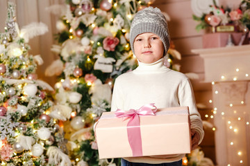 a boy seven years holding a Christmas gift box