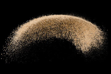 Sand flying explosion isolated on black background ,throwing freeze stop motion object design