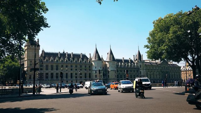 La Conciergerie Castle and Busy street traffic in Paris, France