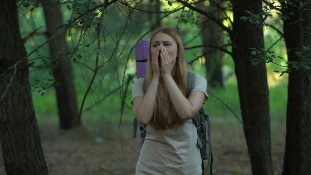 Girl screaming for help while trekking, lost in woods, solo camper, orienteering