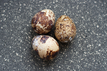 Fototapeta na wymiar quail eggs on black background