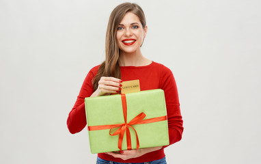 Fototapeta premium happy woman holding gift box with credit card