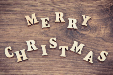 Fototapeta premium Vintage photo, Inscription Merry Christmas on rustic board, festive time concept