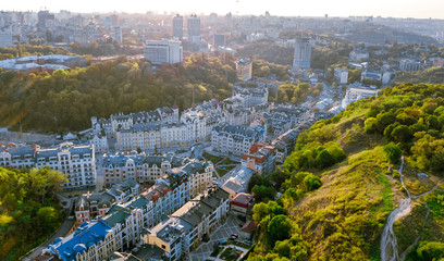 Aerial top view of Kyiv cityscape of Vozdvizhenka and Podol historical districts on sunset from above, city of Kiev, Ukraine

