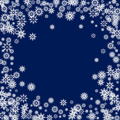 Falling white snowflakes on dark blue background. Snow background. Snowflakes for design Christmas and New Year banners and cards.