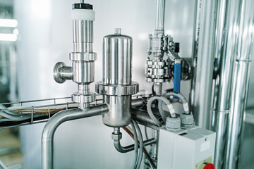 Production of milk and yogurt at the plant. Metal units and tanks for storage and transportation.