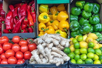 Peppers, tomatoes, ginger and lime for sale at a market