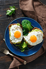 Healthy breakfast top view avocado toasts fried eggs