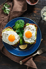 Healthy breakfast avocado toasts fried egg cheerful faces Top view healthy table