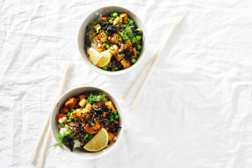 Two vegetarian poke bowl Tofu rice seaweed green peas vegetarian food Top view flat lay
