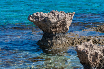 Stone protrudes above a sea surface, Cyprus