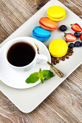 Cup of coffee and pastry on wooden background