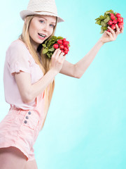 Young woman holding radish