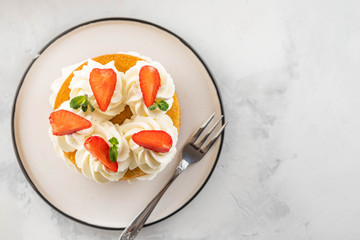 Strawberry cake with vanilla cream on white background. Copy space.