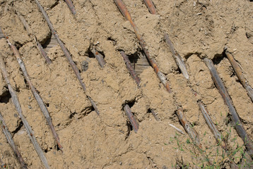 Background of wooden plank in mud, clay wall
