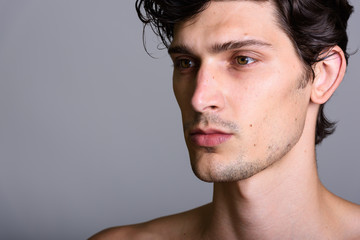 Fototapeta premium Close up of young handsome Brazilian man looking at distance shirtless