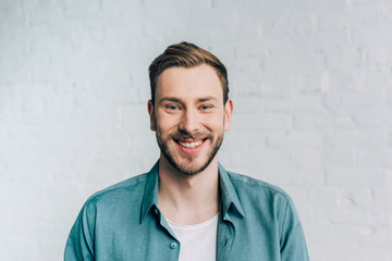 close up portrait of laughing young man looking at camera