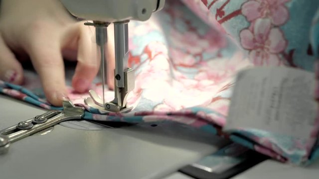 Close up view of sewing machine making stitch on fabric fashion clothes
