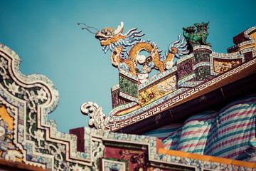 Detailed view of dragons on Citadel the Imperial City with the Purple Forbidden City in Hue, Vietnam.