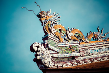 Detailed view of dragons on Citadel the Imperial City with the Purple Forbidden City in Hue, Vietnam.
